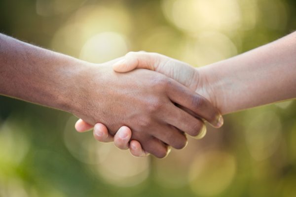 Community, handshake and support hand sign of diversity to show solidarity and trust. Welcome or gr.