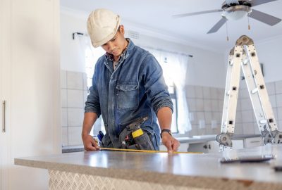 Construction, measurement and handyman doing home repair, renovation and building a counter. Servic.